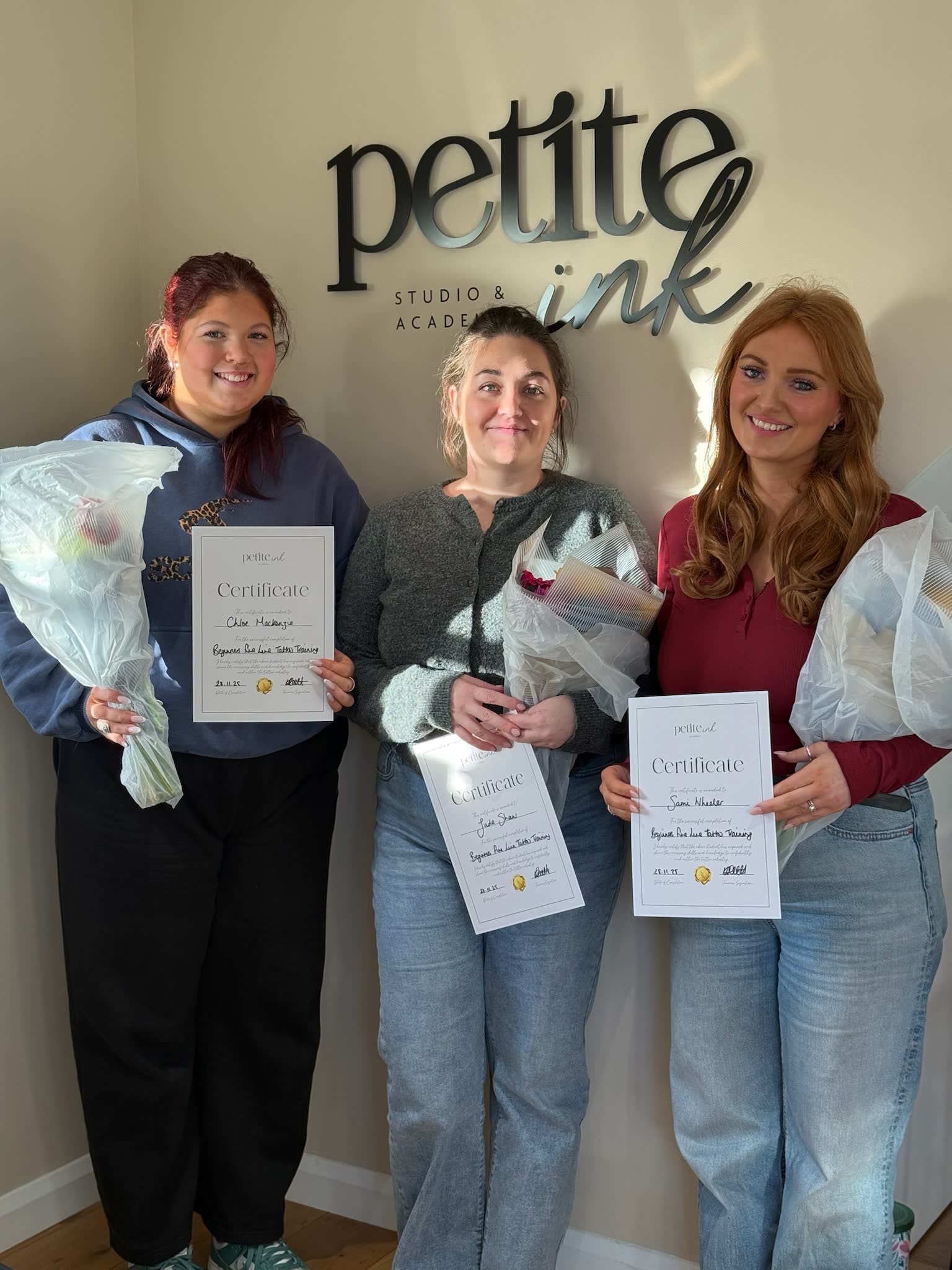 A graduating cohort holding their certificates